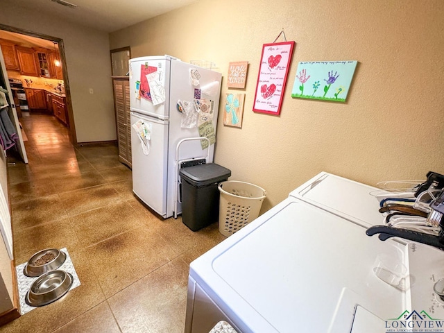 clothes washing area featuring independent washer and dryer