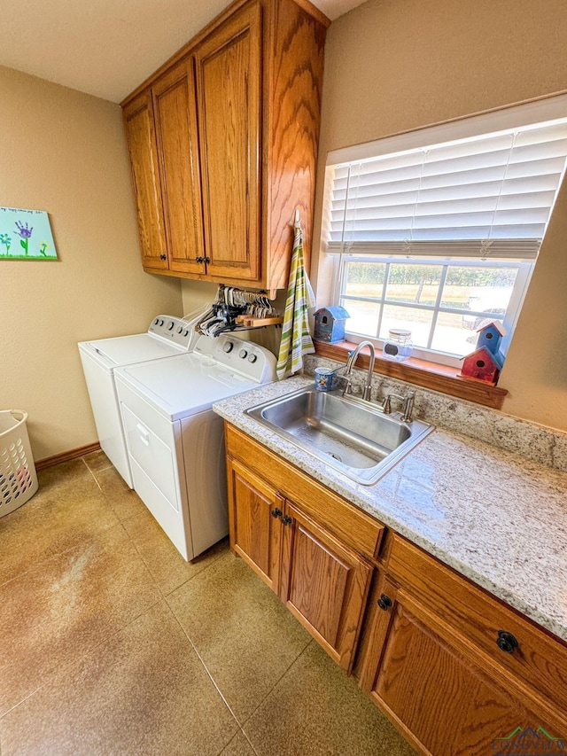 washroom featuring cabinets, independent washer and dryer, and sink