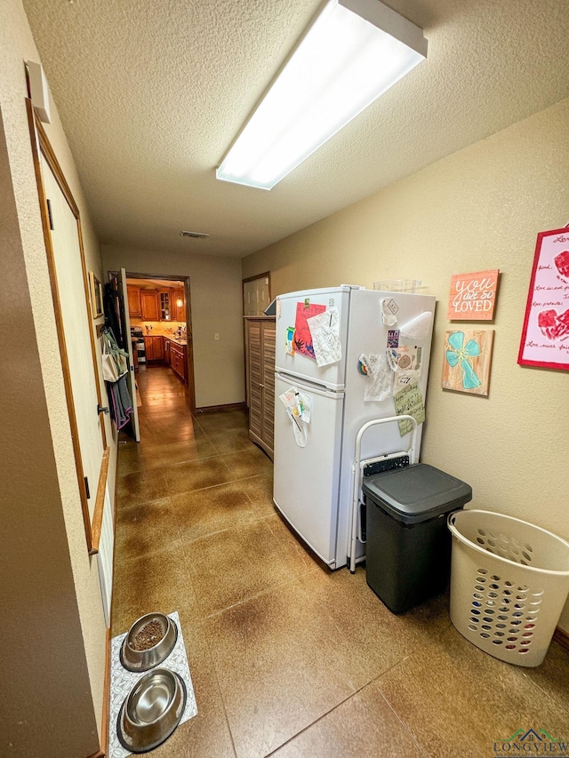 laundry area featuring a textured ceiling