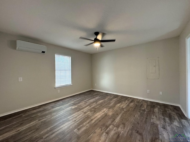 spare room featuring dark wood-type flooring, a wall unit AC, ceiling fan, and electric panel