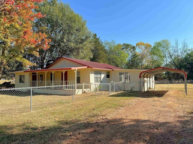 view of front facade with a front lawn and a carport