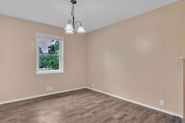 4202 Brent Rd, Longview, TX 75604 - unfurnished room with a chandelier, wood finished floors, and baseboards