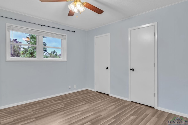 4202 Brent Rd, Longview, TX 75604 - unfurnished bedroom with light wood finished floors, baseboards, crown molding, and ceiling fan