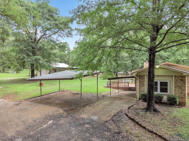 4202 Brent Rd, Longview, TX 75604 - view of grassy yard with a detached carport and driveway