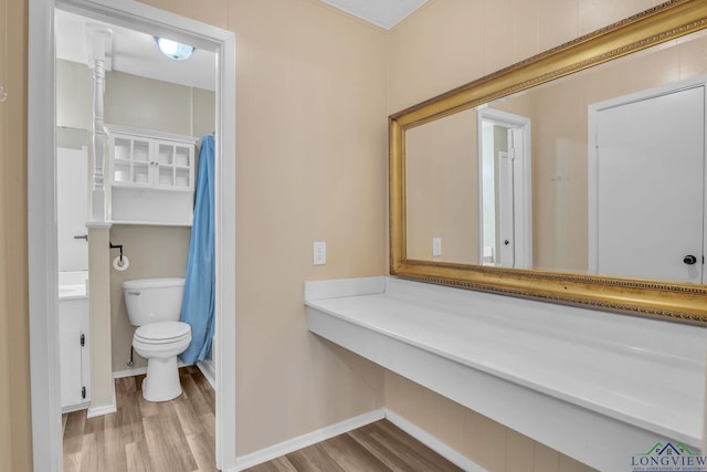 4202 Brent Rd, Longview, TX 75604 - bathroom featuring wood finished floors, toilet, baseboards, and vanity