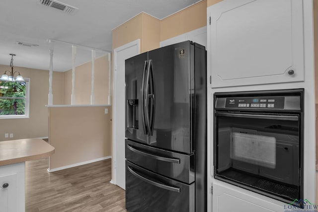 4202 Brent Rd, Longview, TX 75604 - kitchen with black appliances, light wood-type flooring, baseboards, a chandelier, and hanging light fixtures