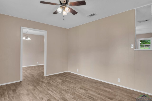 4202 Brent Rd, Longview, TX 75604 - empty room featuring wood finished floors, ceiling fan, a chandelier, and baseboards
