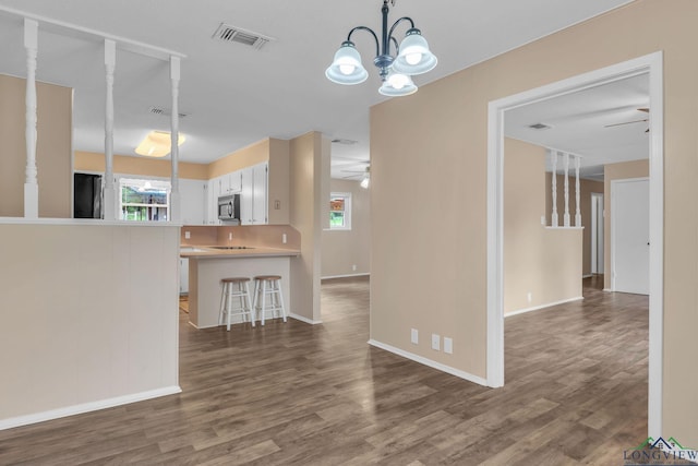 4202 Brent Rd, Longview, TX 75604 - kitchen featuring light countertops, wood finished floors, a ceiling fan, and hanging light fixtures
