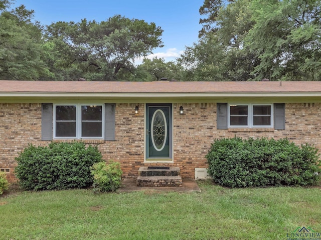 4202 Brent Rd, Longview, TX 75604 - view of front of home with entry steps, a front yard, and brick siding