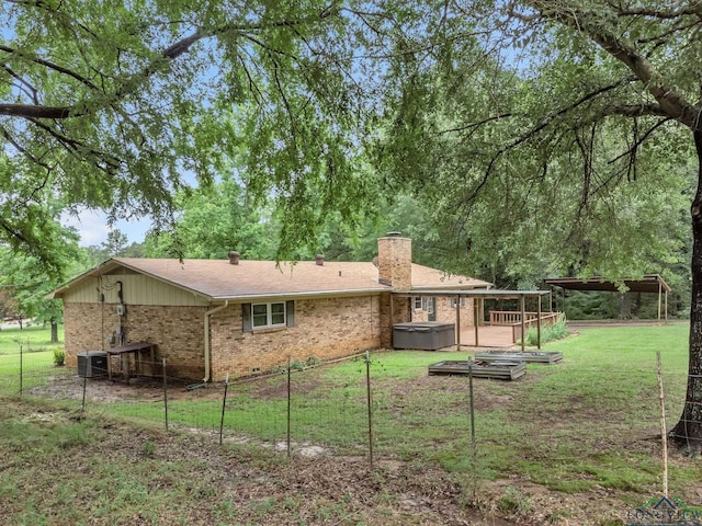 4202 Brent Rd, Longview, TX 75604 - back of property with brick siding, a chimney, a hot tub, and cooling unit