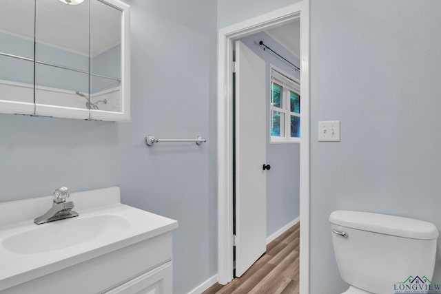 4202 Brent Rd, Longview, TX 75604 - bathroom with toilet, vanity, wood finished floors, and baseboards