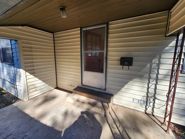 view of exterior entry with log veneer siding