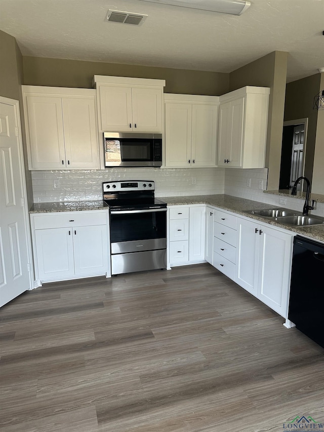 kitchen featuring light hardwood / wood-style floors, white cabinetry, sink, and appliances with stainless steel finishes