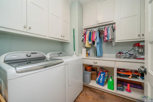 10740 Fm 2685, Gladewater, TX 75647 - laundry room featuring washing machine and clothes dryer, cabinet space, and wood finished floors