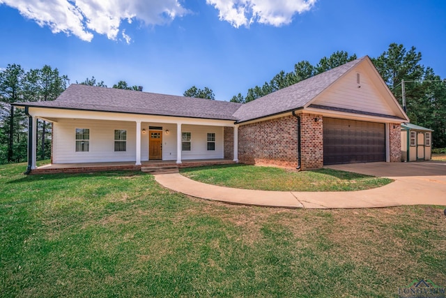 10740 Fm 2685, Gladewater, TX 75647 - ranch-style home with a garage, a porch, concrete driveway, a front yard, and brick siding