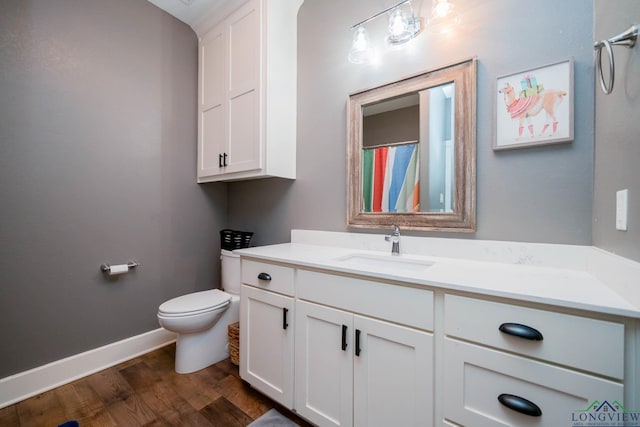 10740 Fm 2685, Gladewater, TX 75647 - full bath featuring wood finished floors, vanity, toilet, and baseboards