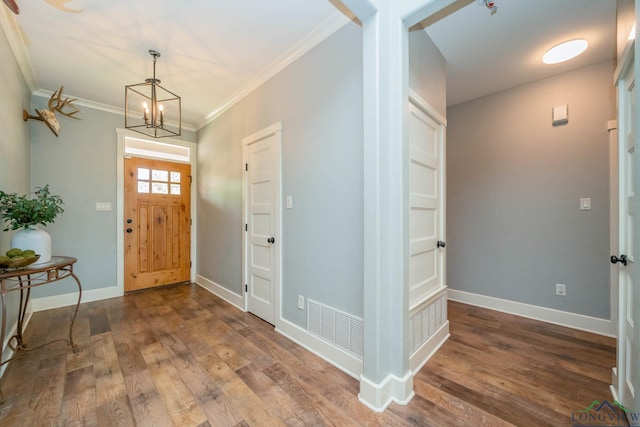10740 Fm 2685, Gladewater, TX 75647 - foyer featuring a chandelier, dark wood-style flooring, crown molding, and baseboards