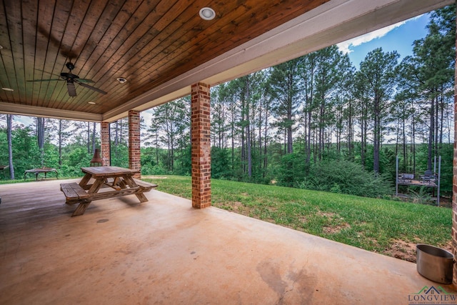 10740 Fm 2685, Gladewater, TX 75647 - view of patio featuring a ceiling fan and view of wooded area