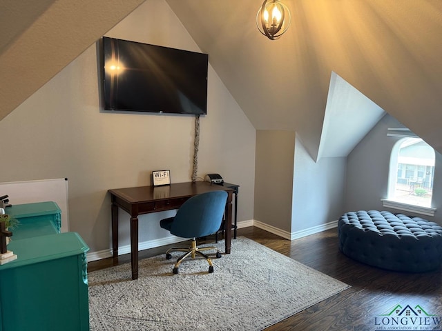 office area featuring baseboards, wood finished floors, and vaulted ceiling