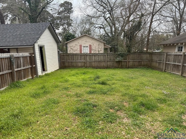 view of yard with an outdoor structure and a fenced backyard