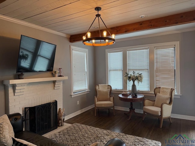 sitting room featuring an inviting chandelier, beamed ceiling, wood finished floors, and baseboards