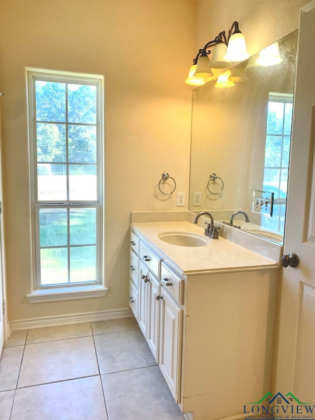 bathroom with tile patterned floors, plenty of natural light, and vanity