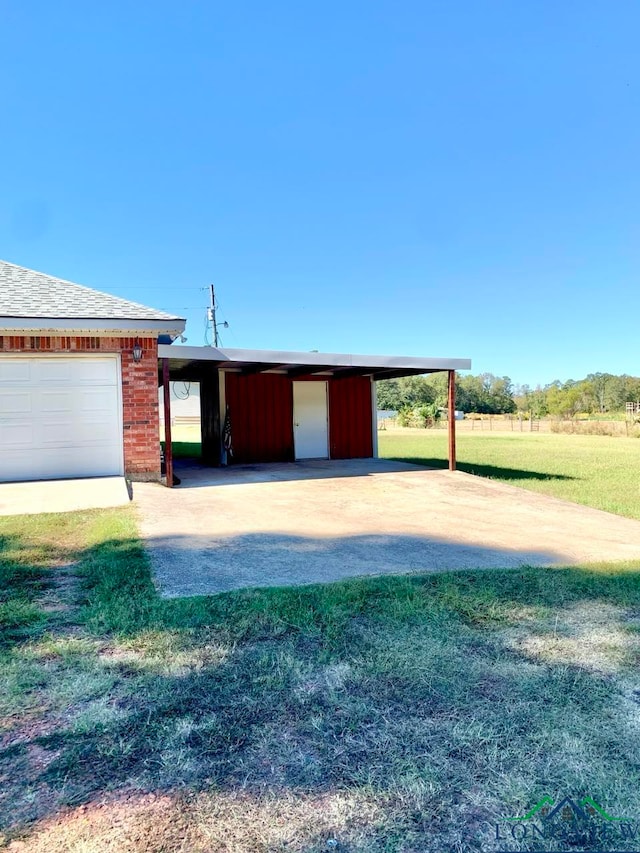 view of front facade featuring a carport, a garage, an outbuilding, and a front lawn