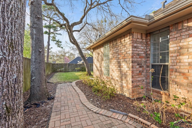 3314 Storey Lk, Tyler, TX 75707 - view of home's exterior with a fenced backyard, brick siding, and a yard