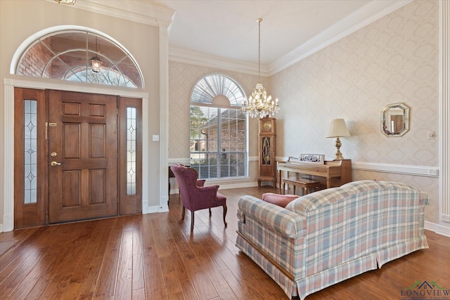3314 Storey Lk, Tyler, TX 75707 - foyer entrance featuring wallpapered walls, hardwood / wood-style floors, ornamental molding, and an inviting chandelier