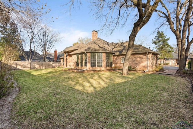 3314 Storey Lk, Tyler, TX 75707 - rear view of house featuring brick siding, a lawn, a chimney, and a fenced backyard