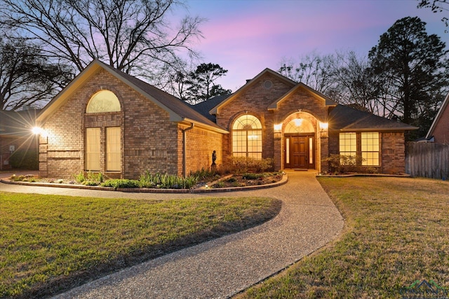 3314 Storey Lk, Tyler, TX 75707 - ranch-style home featuring brick siding, a lawn, and fence