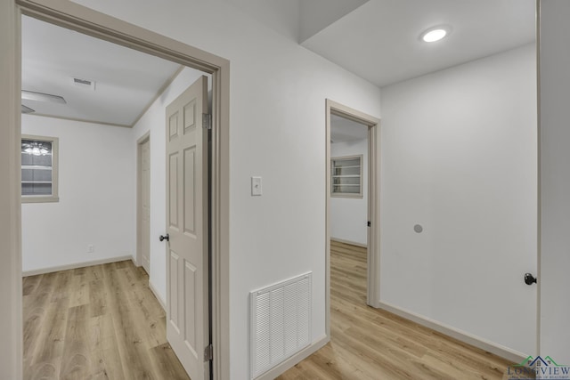 hall with light hardwood / wood-style flooring