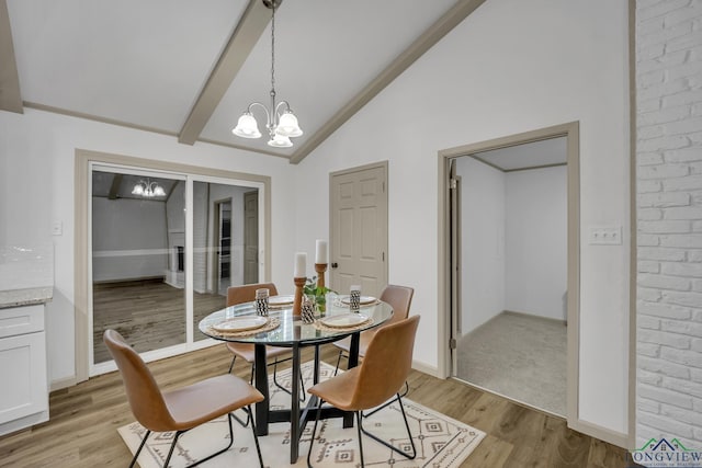 dining space featuring vaulted ceiling with beams, a notable chandelier, and light wood-type flooring