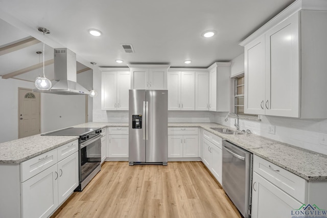 kitchen featuring white cabinets, island range hood, and appliances with stainless steel finishes