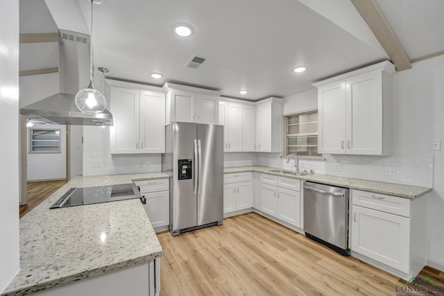 kitchen with island exhaust hood, appliances with stainless steel finishes, decorative light fixtures, and white cabinetry