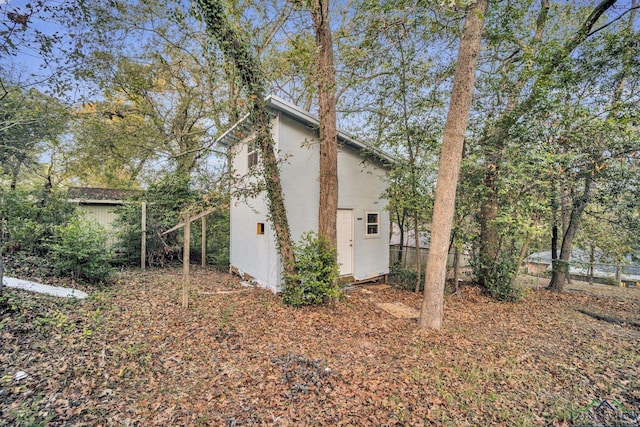 view of home's exterior with a storage shed