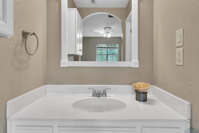 bathroom with vanity and a textured ceiling