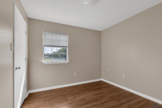 unfurnished room featuring hardwood / wood-style floors and a textured ceiling