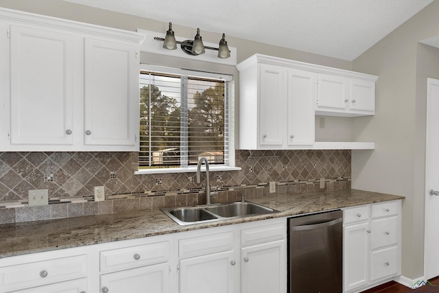 kitchen with dishwasher, decorative backsplash, white cabinetry, and sink