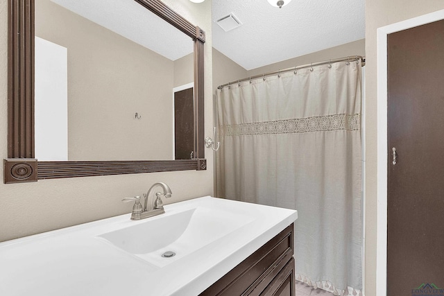 bathroom featuring vanity and a textured ceiling