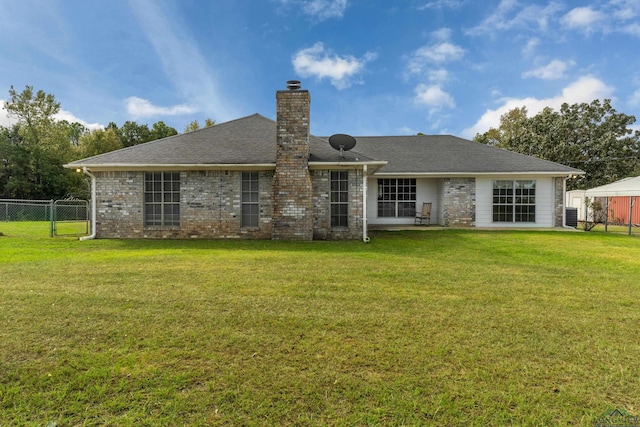 rear view of property featuring a yard