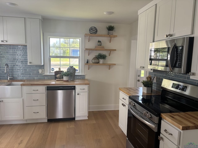 20505 Flat Creek Dr, Chandler, TX 75758 - kitchen with wooden counters, appliances with stainless steel finishes, backsplash, and open shelves