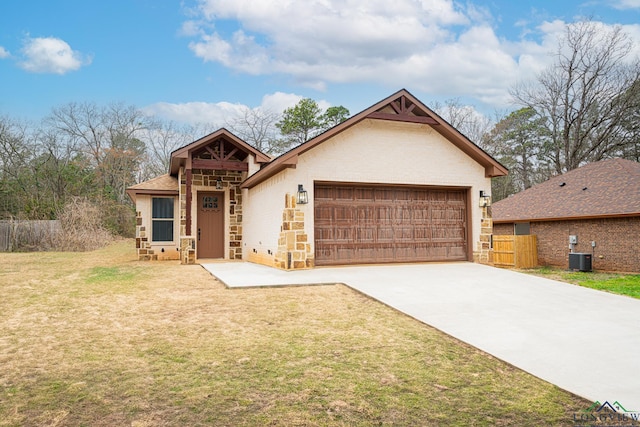 view of front of house with a garage, a front yard, and central air condition unit