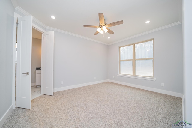 spare room with crown molding, ceiling fan, and light carpet