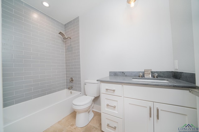 full bathroom featuring tiled shower / bath, vanity, toilet, and tile patterned flooring