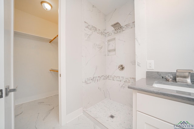 bathroom featuring vanity and a tile shower