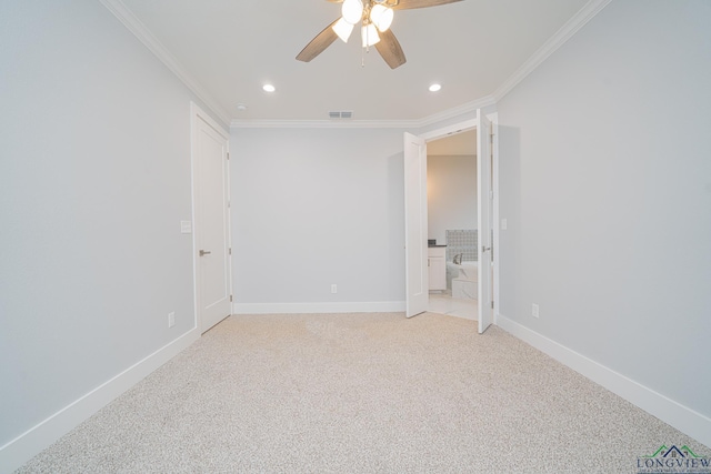 carpeted spare room featuring crown molding and ceiling fan