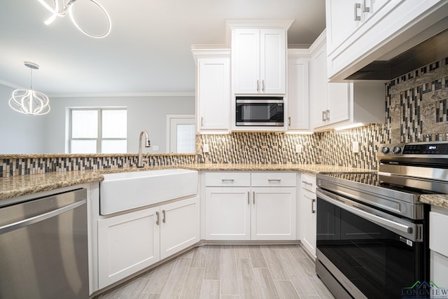 kitchen with premium range hood, sink, white cabinetry, stainless steel appliances, and backsplash