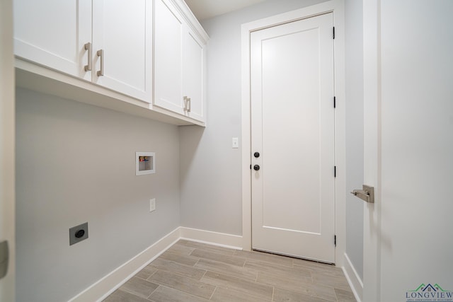 clothes washing area with cabinets, electric dryer hookup, and hookup for a washing machine