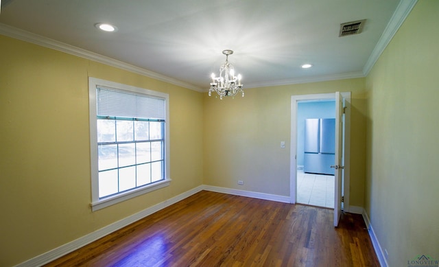 spare room with crown molding, dark hardwood / wood-style floors, and an inviting chandelier